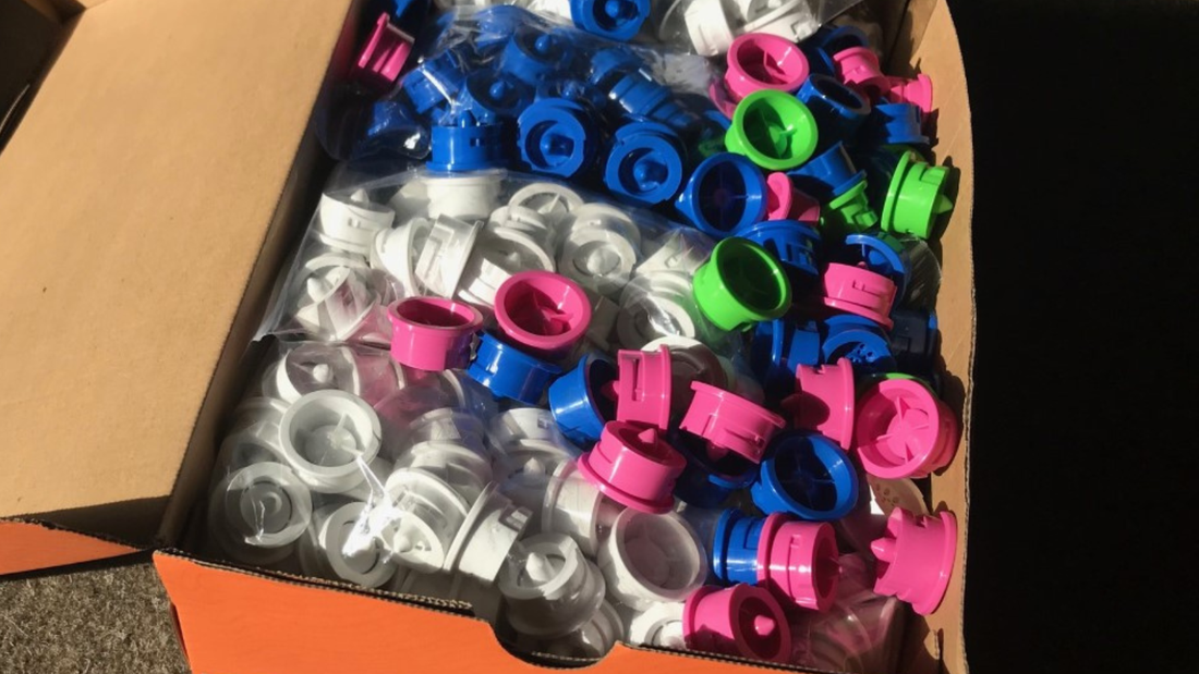 Box of colour-coded Multi-Shower replacement inserts used for routine shower maintenance